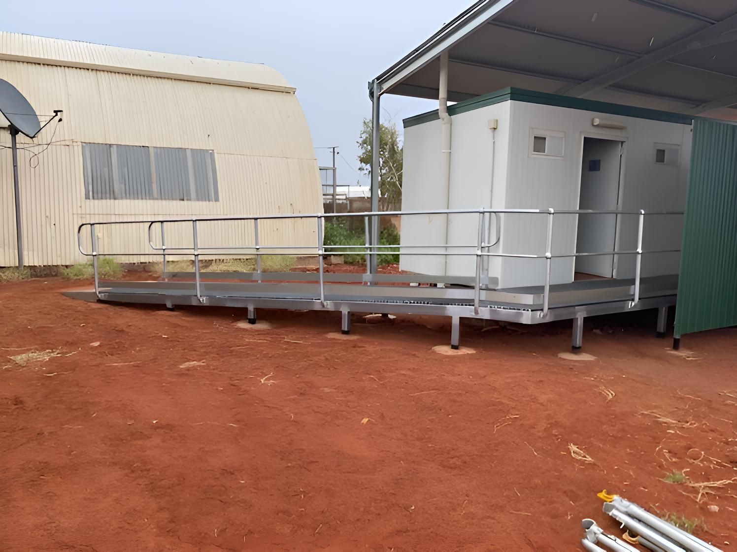 A Ramp Leading To A Building With A Railing — Alice Sheds & Structures In Ciccone, NT