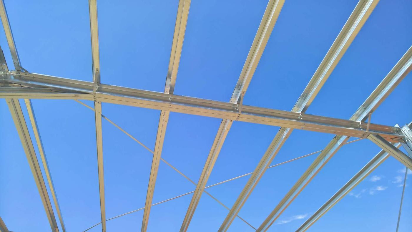 The Ceiling Of A Building With A Blue Sky In The Background — Alice Sheds & Structures In Ciccone, NT