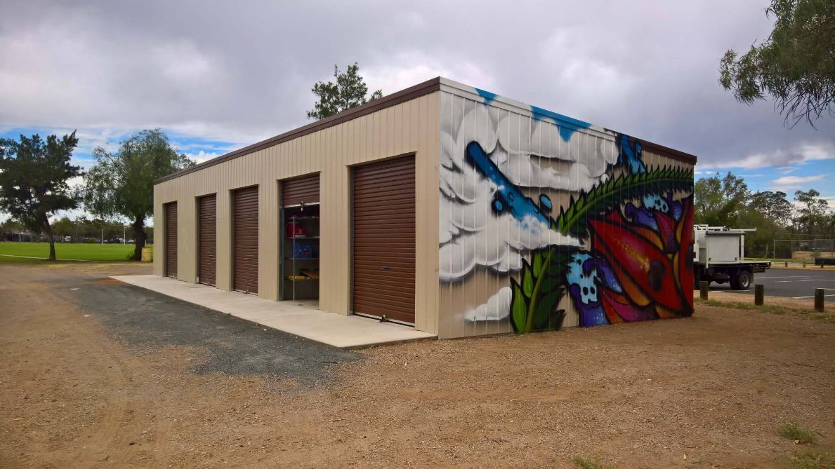 A Building With Graffiti On The Side Of It — Alice Sheds & Structures In Ciccone, NT