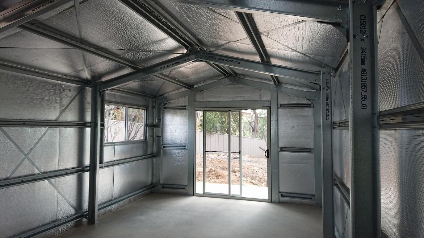 An Empty Room With A Sliding Glass Door And A Metal Structure — Alice Sheds & Structures In Ciccone, NT