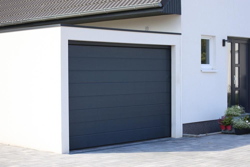 Dark Gray Garage Door on a White House Exterior — Coastal Auto Doors & Gates In Noosa, QLD