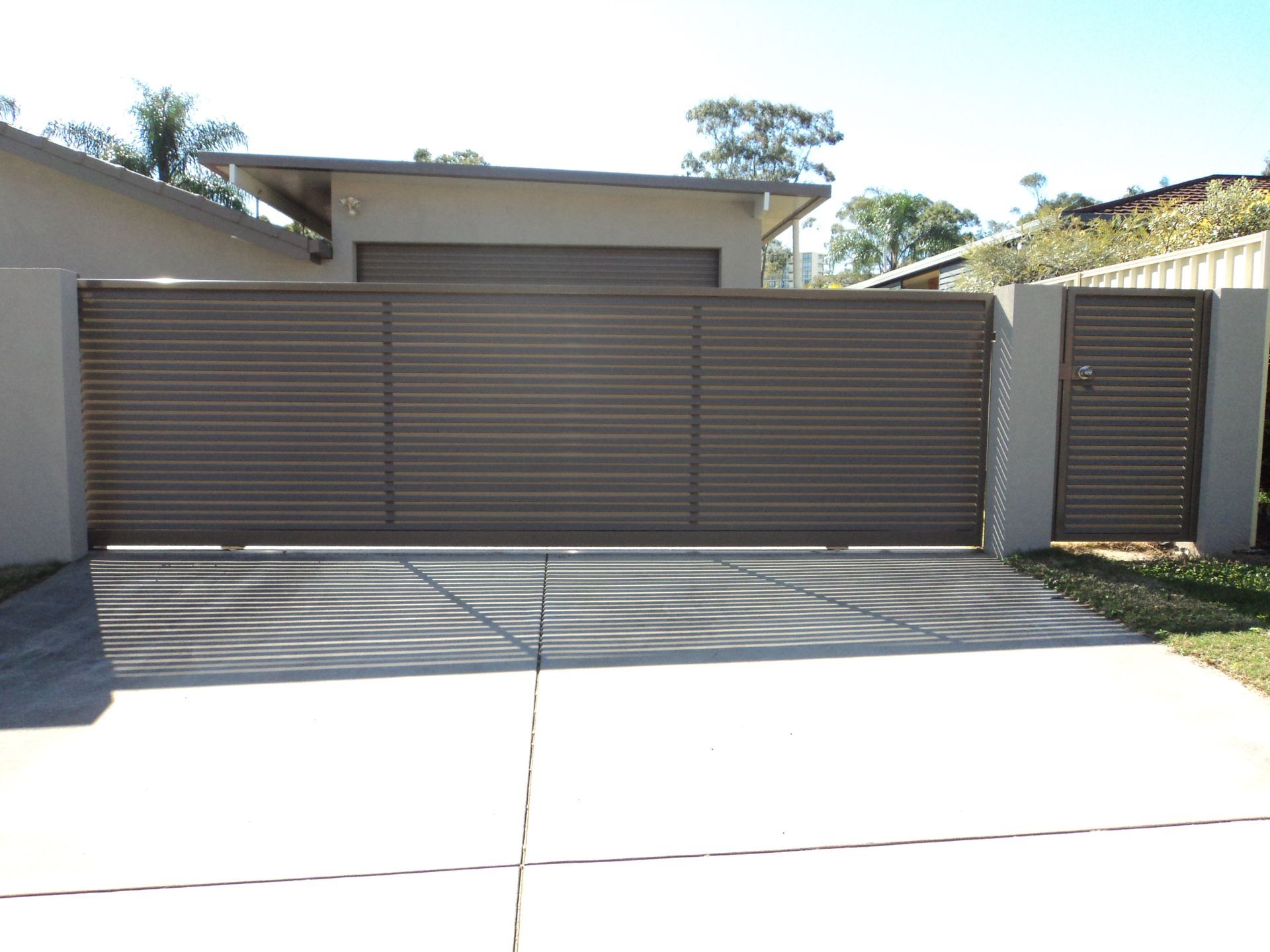 Brown Horizontal Slat Driveway Gate and Pedestrian Gate — Coastal Auto Doors & Gates In Palmwoods, QLD