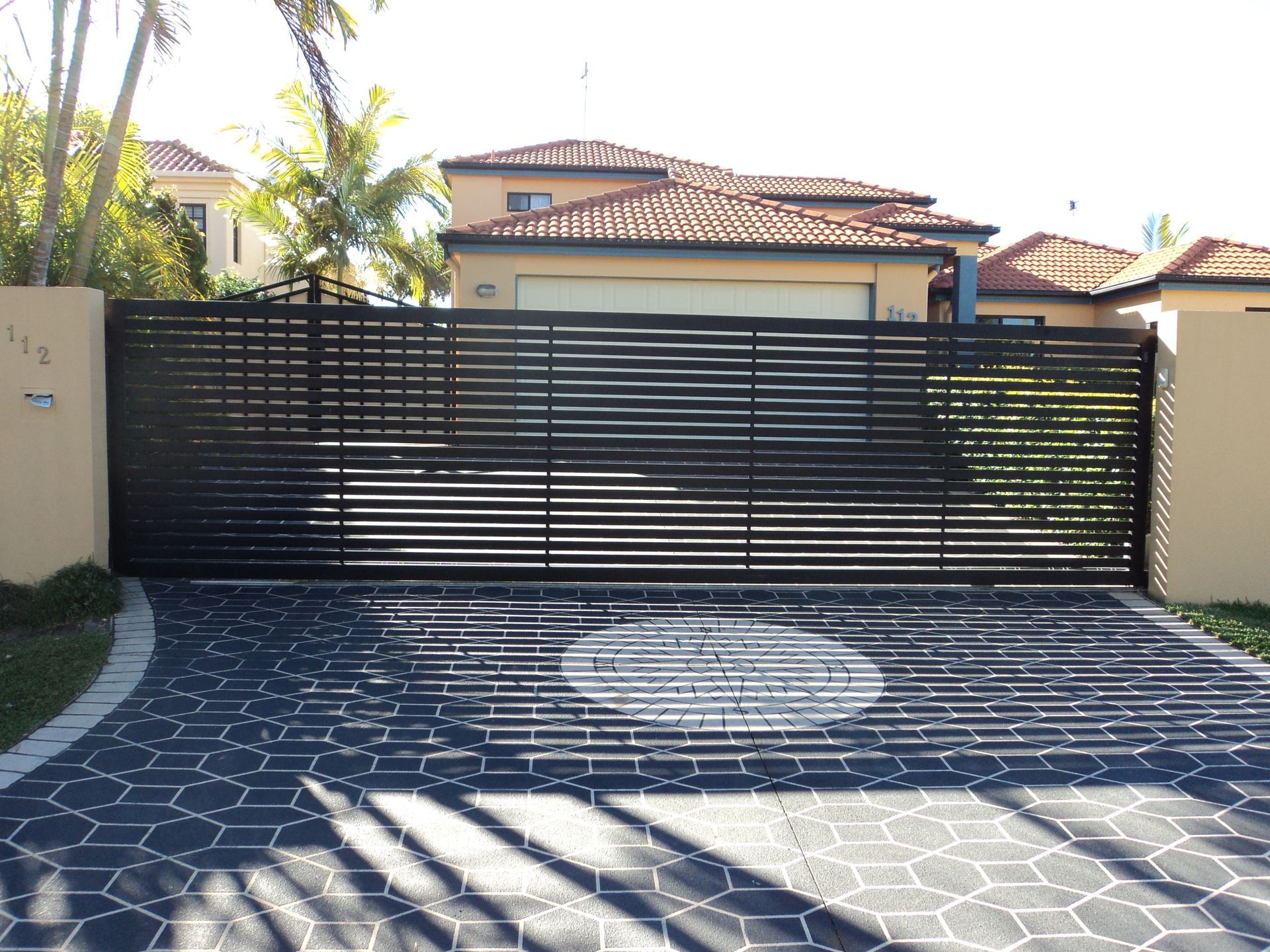 A Automatic Gate In Front Of A Modern House And Hills — Coastal Auto Doors & Gates In Maroochydore, QLD