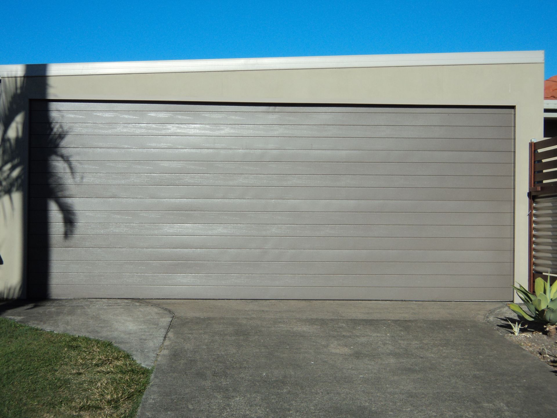 Tan Garage Door, Horizontal Slats, Concrete Driveway, Blue Sky — Coastal Auto Doors & Gates In Sunshine Coast, QLD