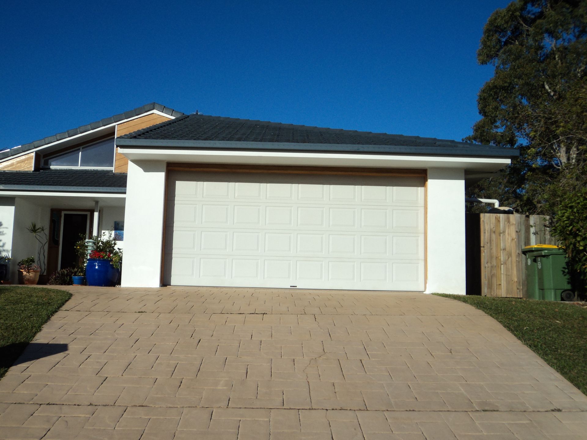 House With a White Garage Door, Driveway, and Blue Sky — Coastal Auto Doors & Gates In Buderim, QLD