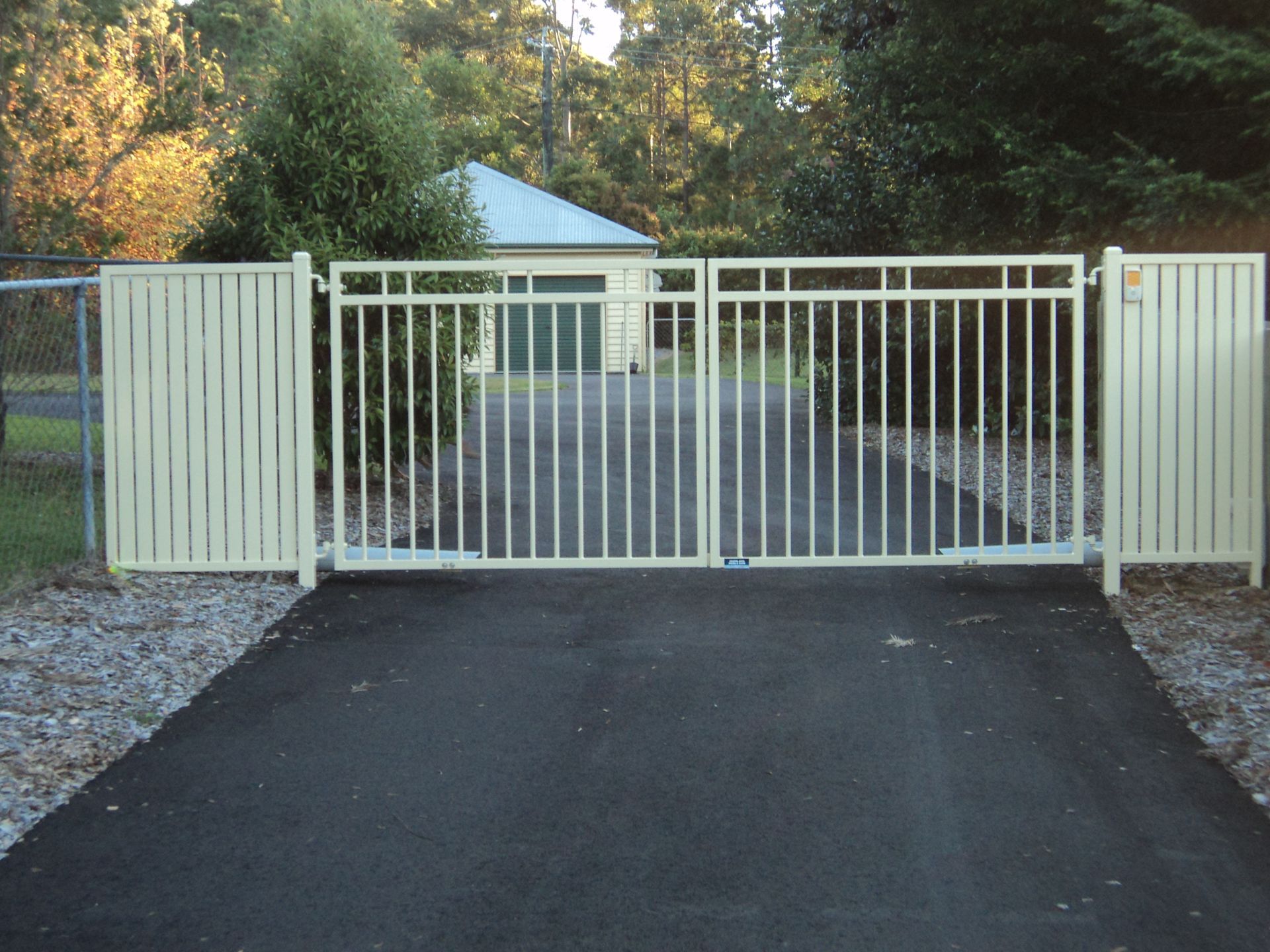 Closed, Cream-colored Metal Driveway Gates — Coastal Auto Doors & Gates In Palmwoods, QLD