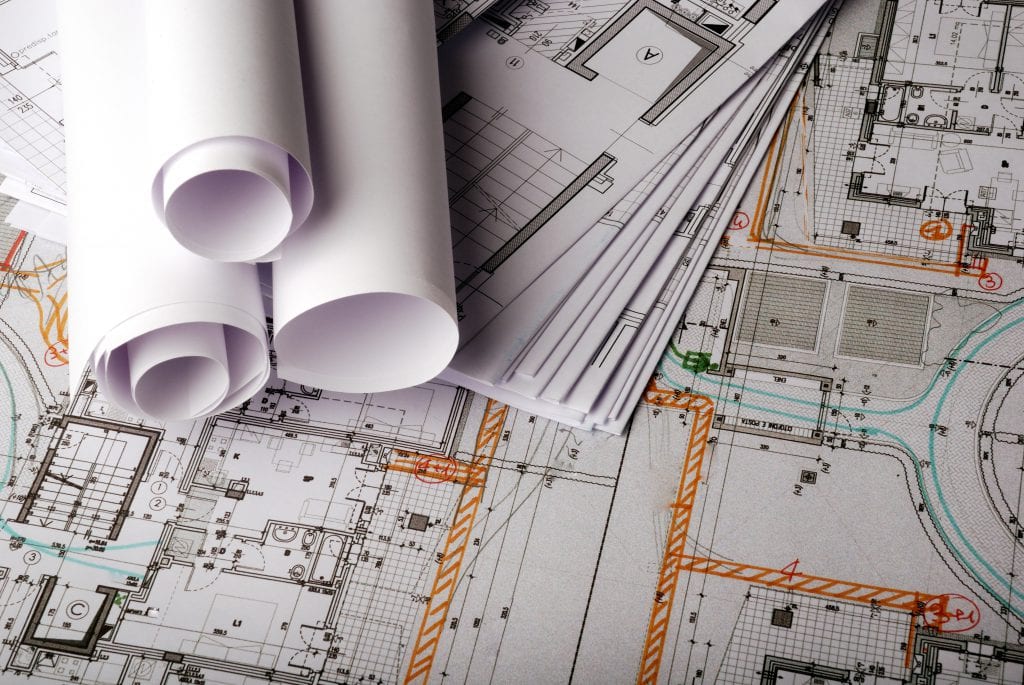 A bunch of rolls of paper are sitting on top of a map.