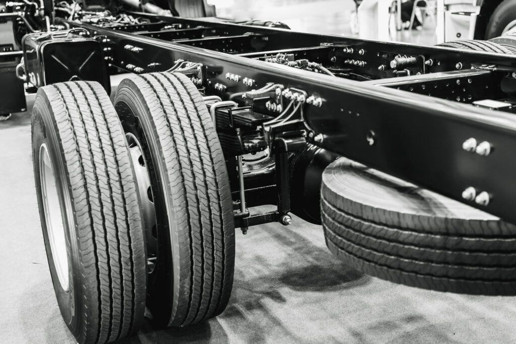 Black aNd White Shot of a Truck Chassis With Two Dual Rear Tires — Burcher EFI & Service Centre in Orange, NSW