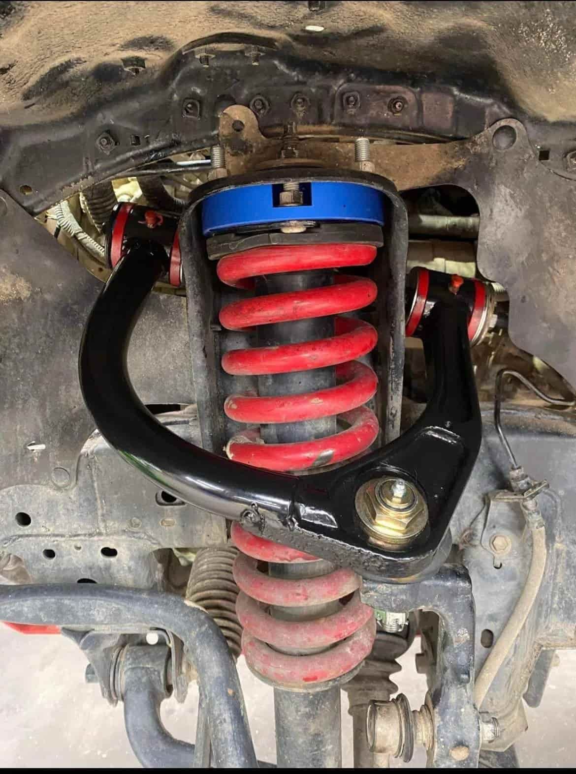 Black Suspension Arms, Red Coil Springs, Blue Spring Spacer — Burcher EFI & Service Centre in Orange, NSW
