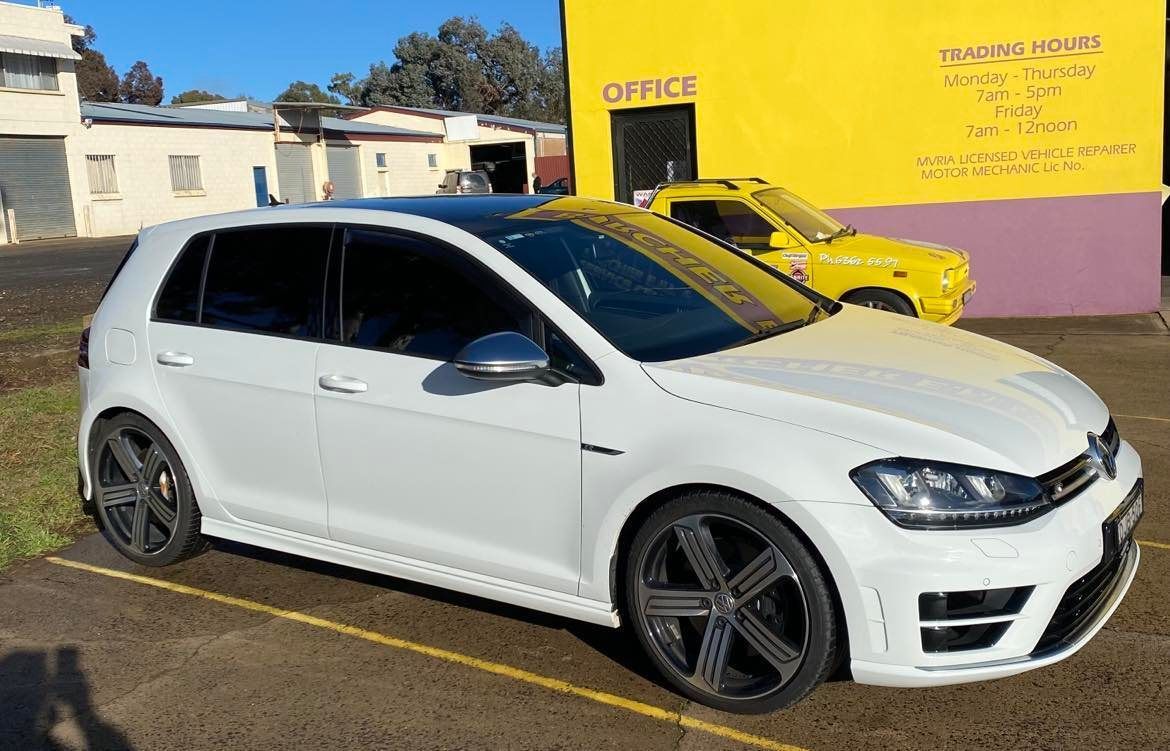 White Volkswagen Golf R Parked in Front of a Yellow Building With a Black Roof  — Burcher EFI & Service Centre in Orange, NSW