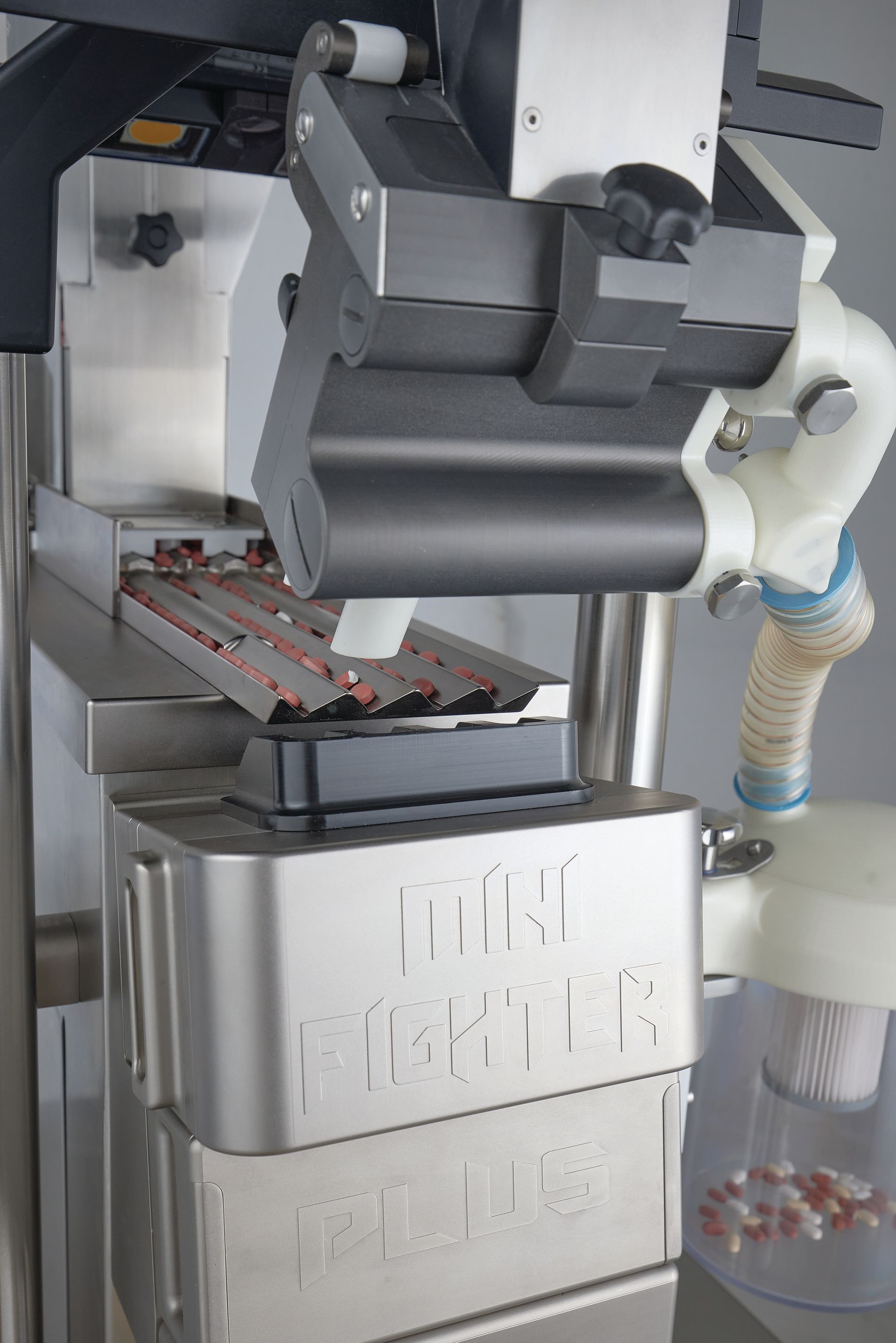 A machine that is making pills is sitting on a table.