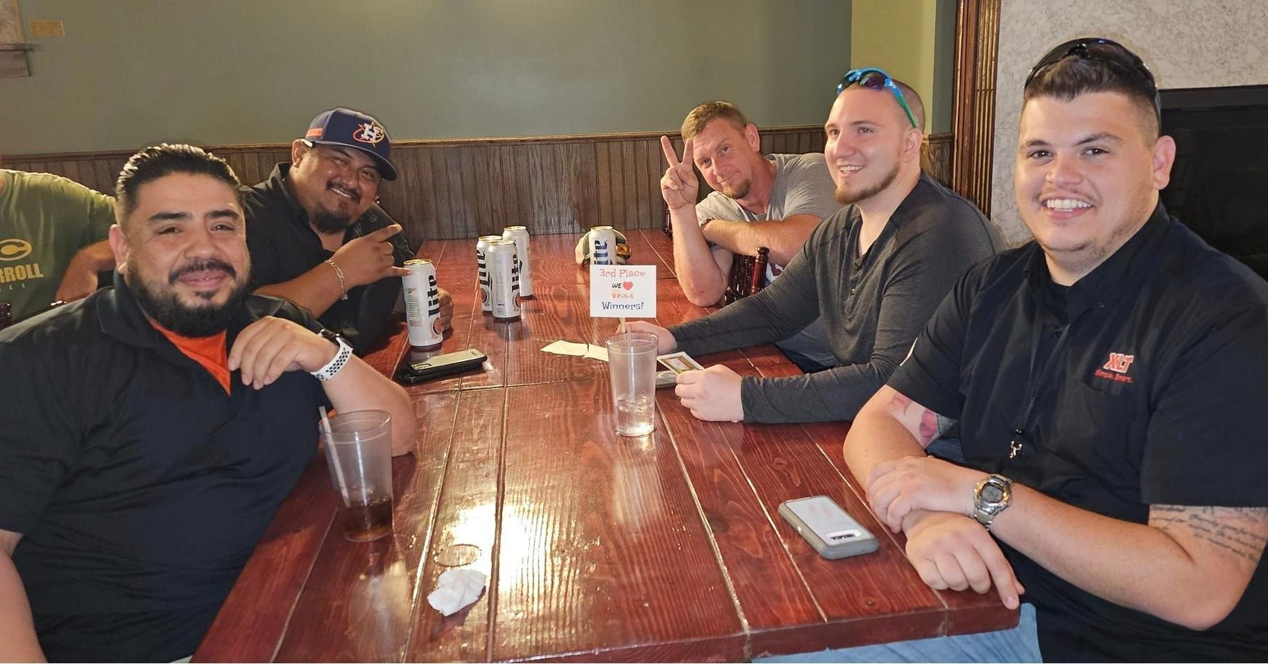 A group of men are sitting at a table in a restaurant.