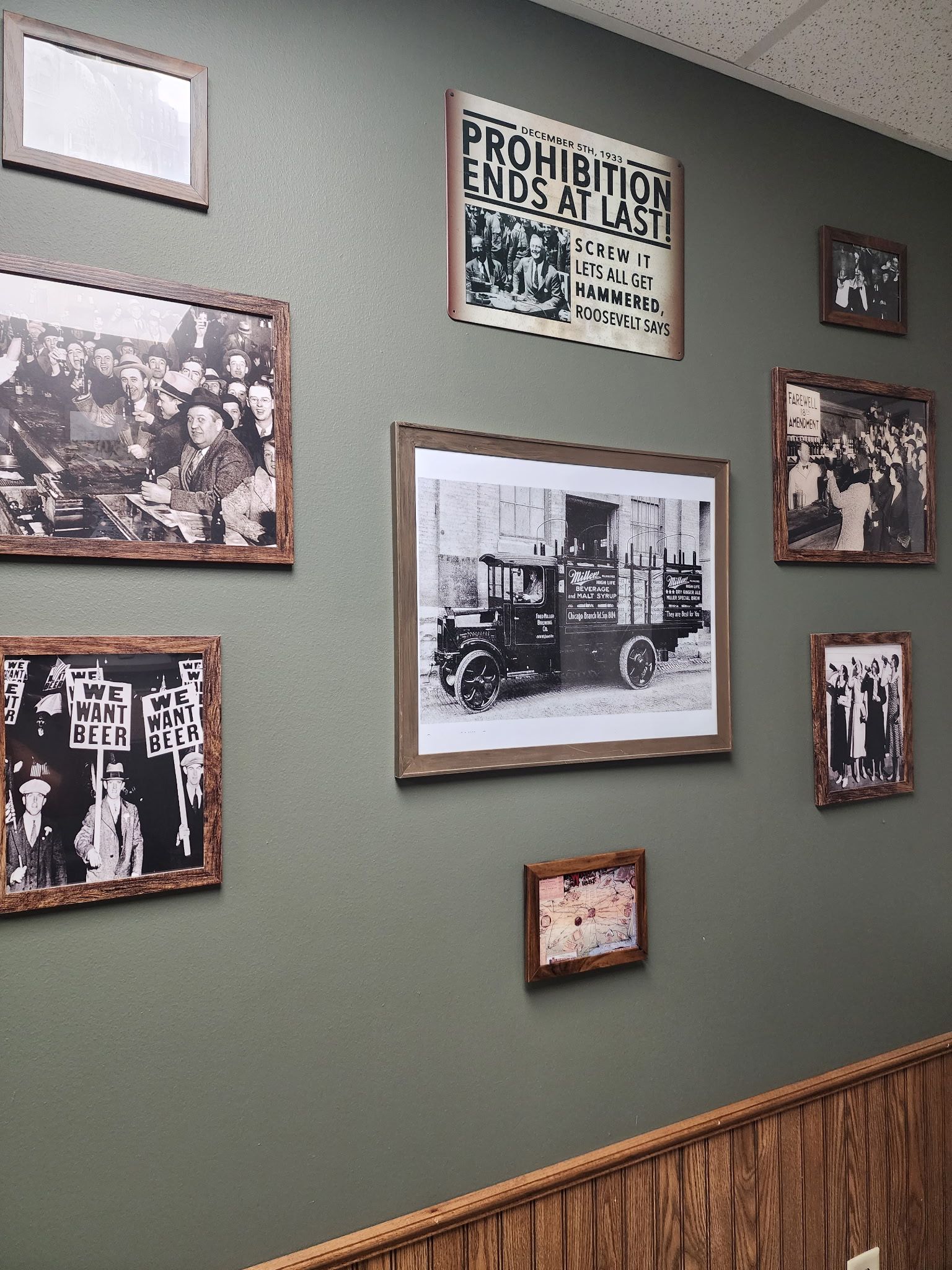 A wall with a lot of framed pictures on it