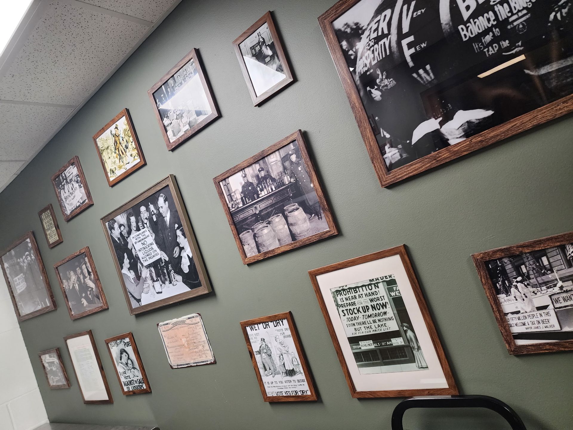 A wall with a lot of framed pictures on it