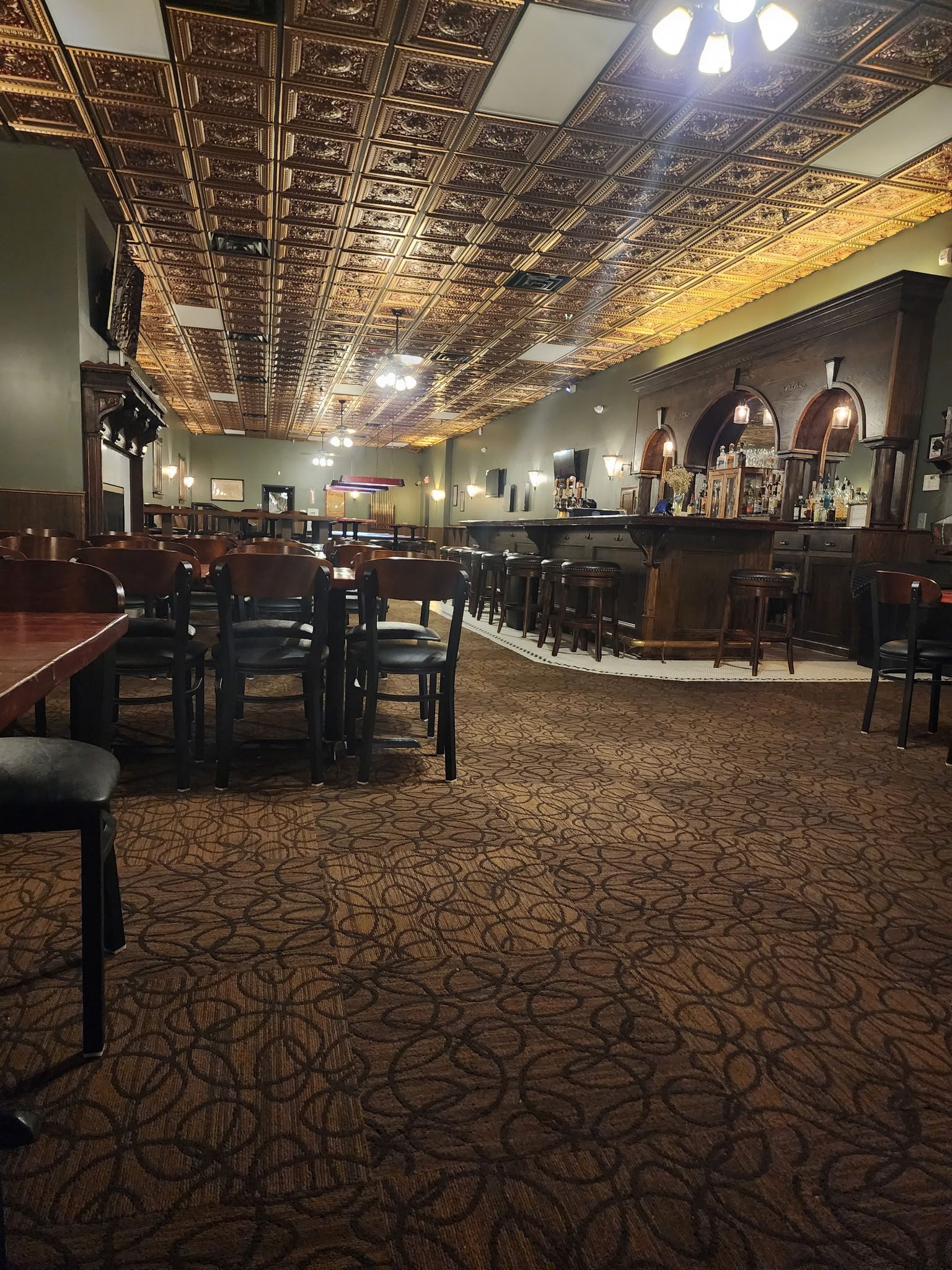 A restaurant with tables and chairs and a bar