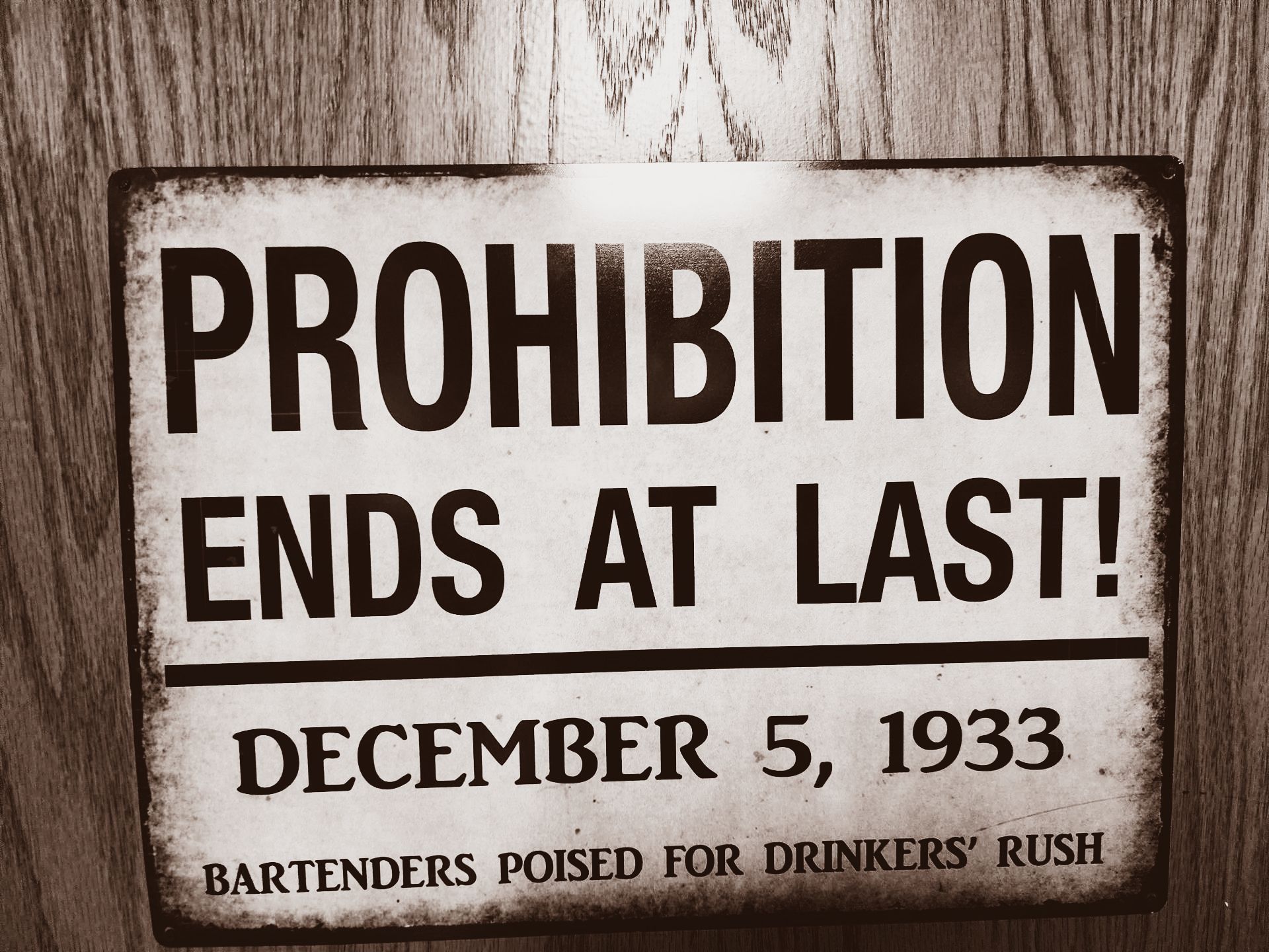 A black and white sign that says prohibition ends at last