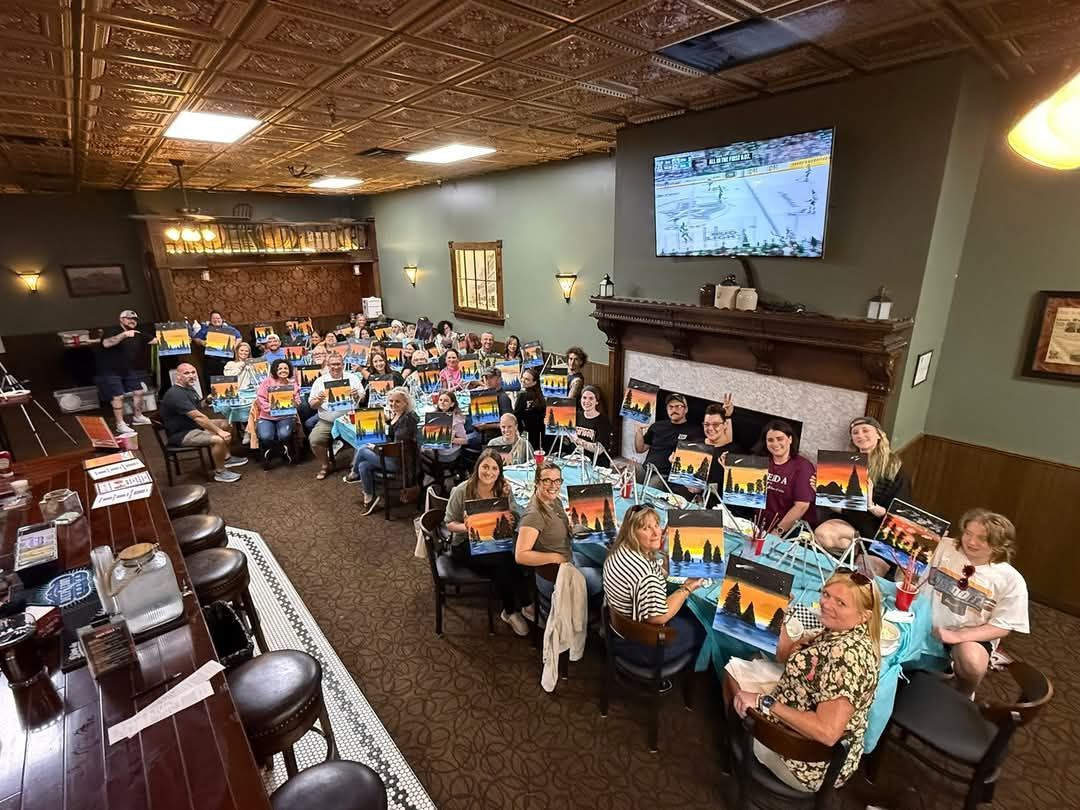 A large group of people are sitting at tables in a restaurant.
