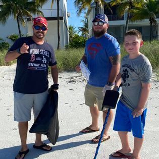 A man wearing a world series shirt is standing next to two other men