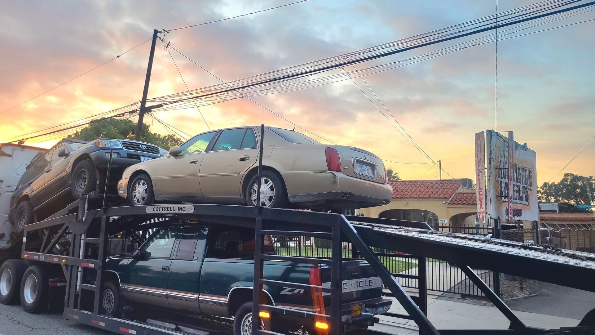 Two cars are sitting on top of each other on a trailer.