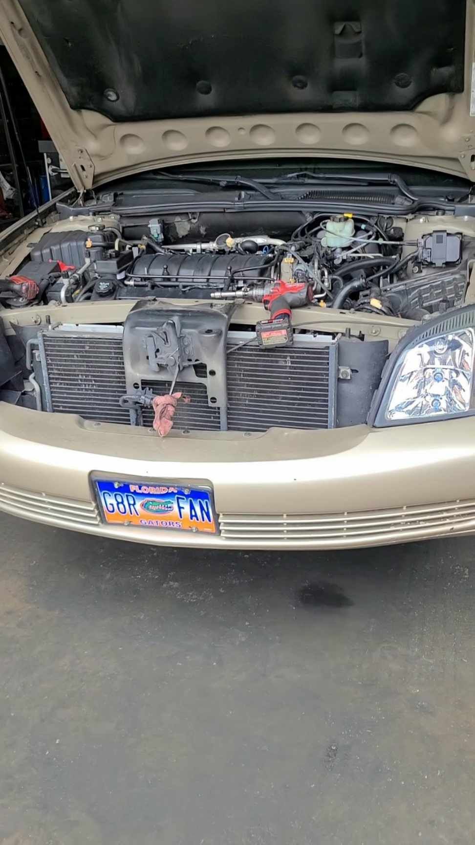 The hood of a car is open and the engine is visible.