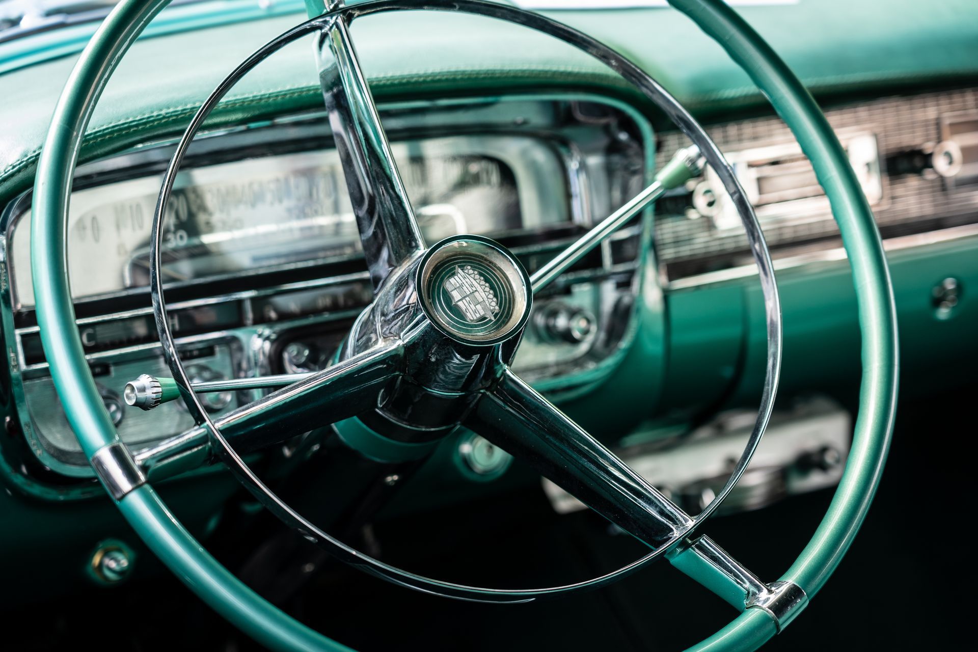 A close up of a green car steering wheel