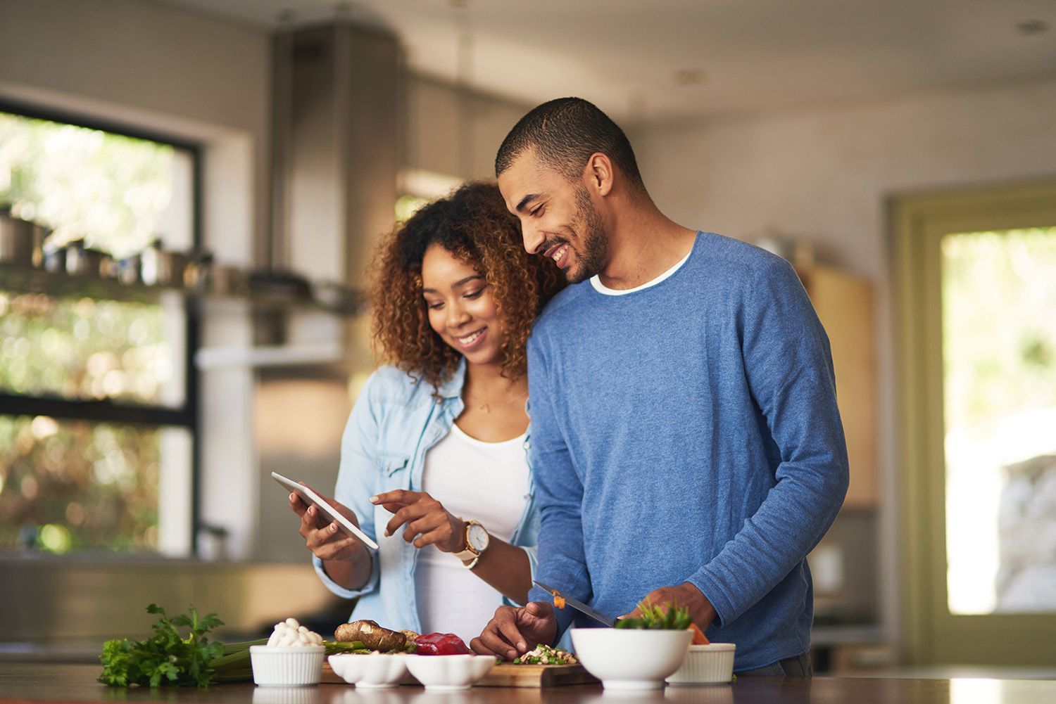 Couple preparing their healthy food in kitchen