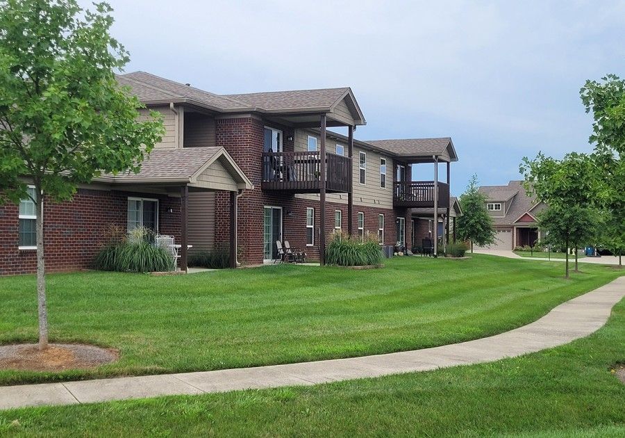 Modern living room with fireplace, TV, sofa, coffee table, and light wood flooring.