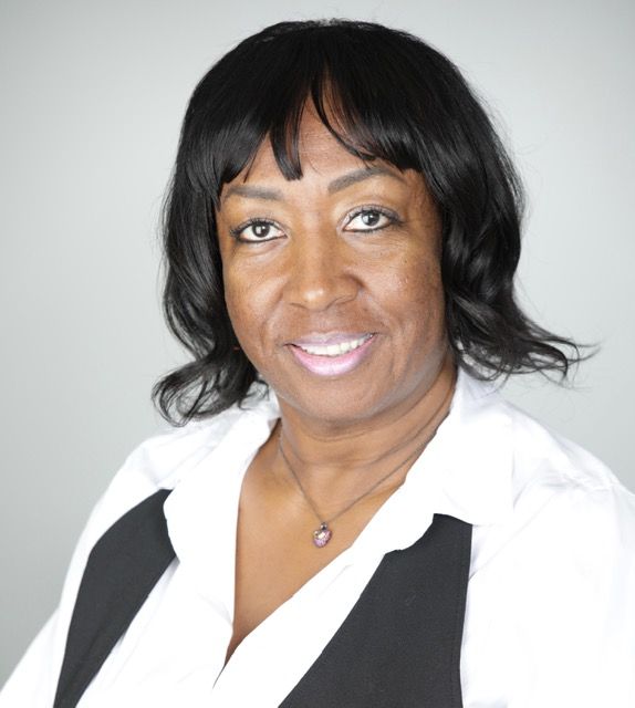 Man with a dark beard and short hair, wearing a black turtleneck and blazer, facing the camera.