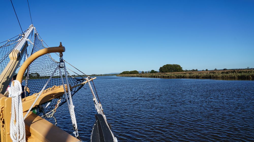 Bow of a Tall Ship Sailing Down a River Under a Clear Blue Sky — Hunter Plumbing And Hotwater in Fern Bay, NSW
