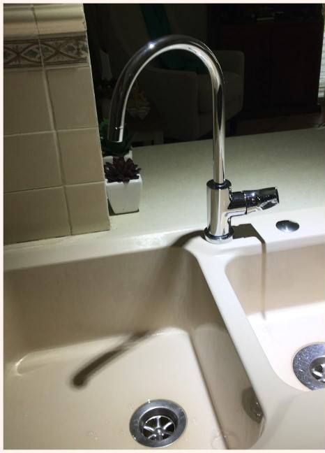 Stainless Steel Kitchen Faucet Over a Cream-colored Sink — Hunter Plumbing And Hotwater in Port Stephens, NSW