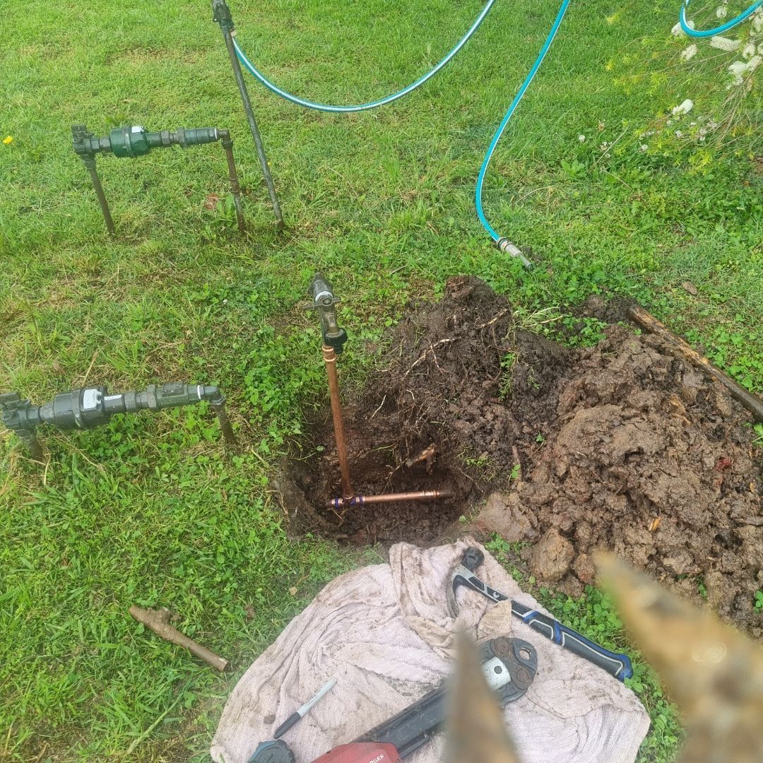 A Yard With Irrigation System Parts, Including Pipes and Valves — Hunter Plumbing And Hotwater in Lemon Tree Passage, NSW