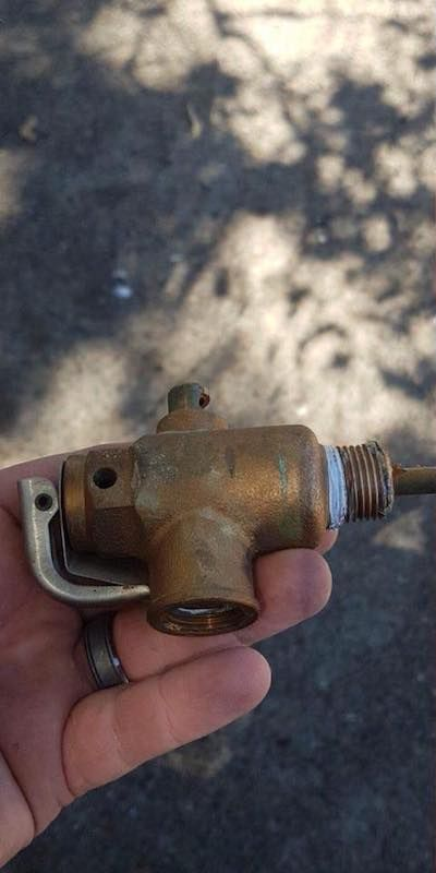 Tarnished Brass Valve Held in a Hand, the Valve Has Lever, Threaded End — Hunter Plumbing And Hotwater in Port Stephens, NSW