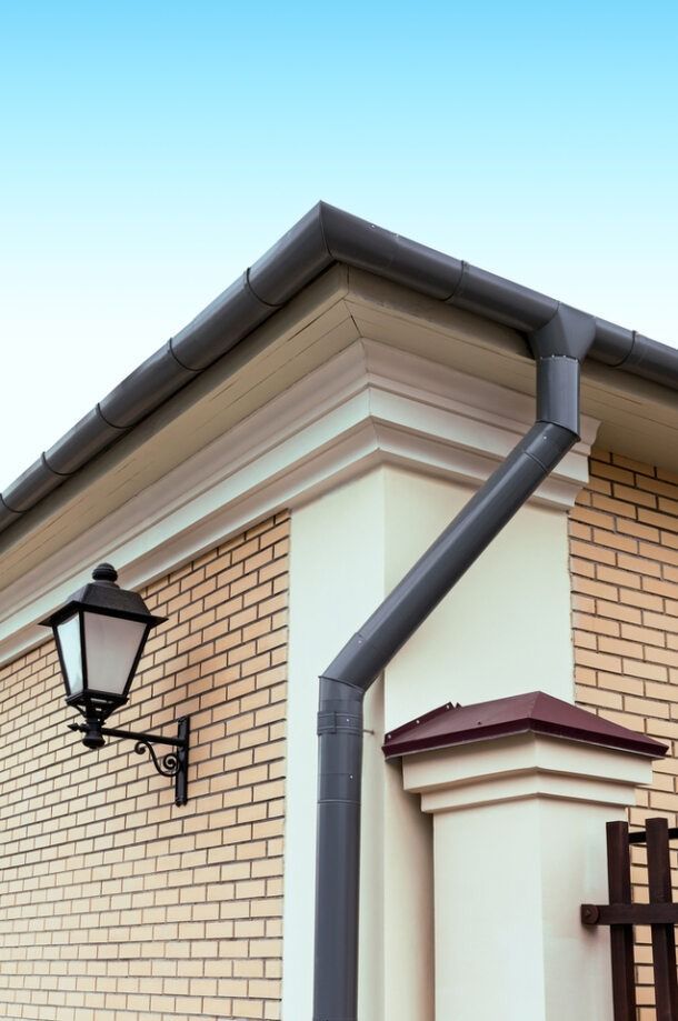 Black roof gutter and downpipe — Qualified Roofer in Canberra