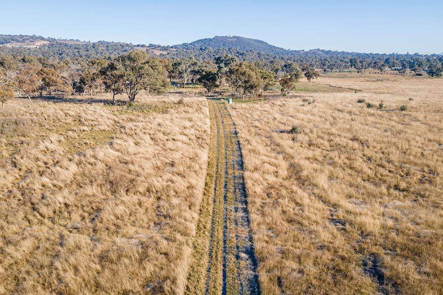 Aerial view of a dirt road — Skilled Roofer in Jerrabomberra