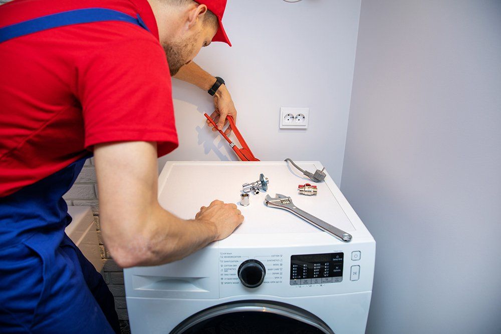 Plumber Installing Washing Machine — Sacramento, CA — Acutech Appliance, Heating & Air