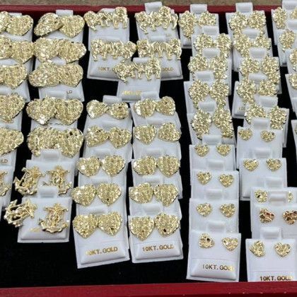 A display of gold jewelry including rings and earrings