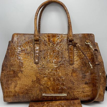 A brown purse with a wallet attached to it