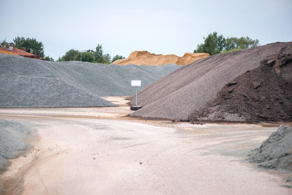 A Large Pile Of Gravel Is Sitting In The Middle Of A Dirt Field — Dubbo Mini Mix & Landscape Supplies In Dubbo, NSW