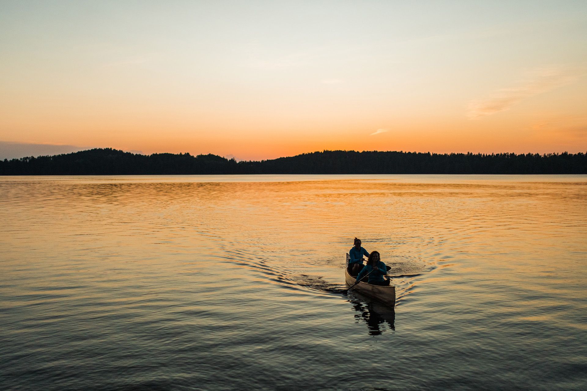 canoe paddling at sunset