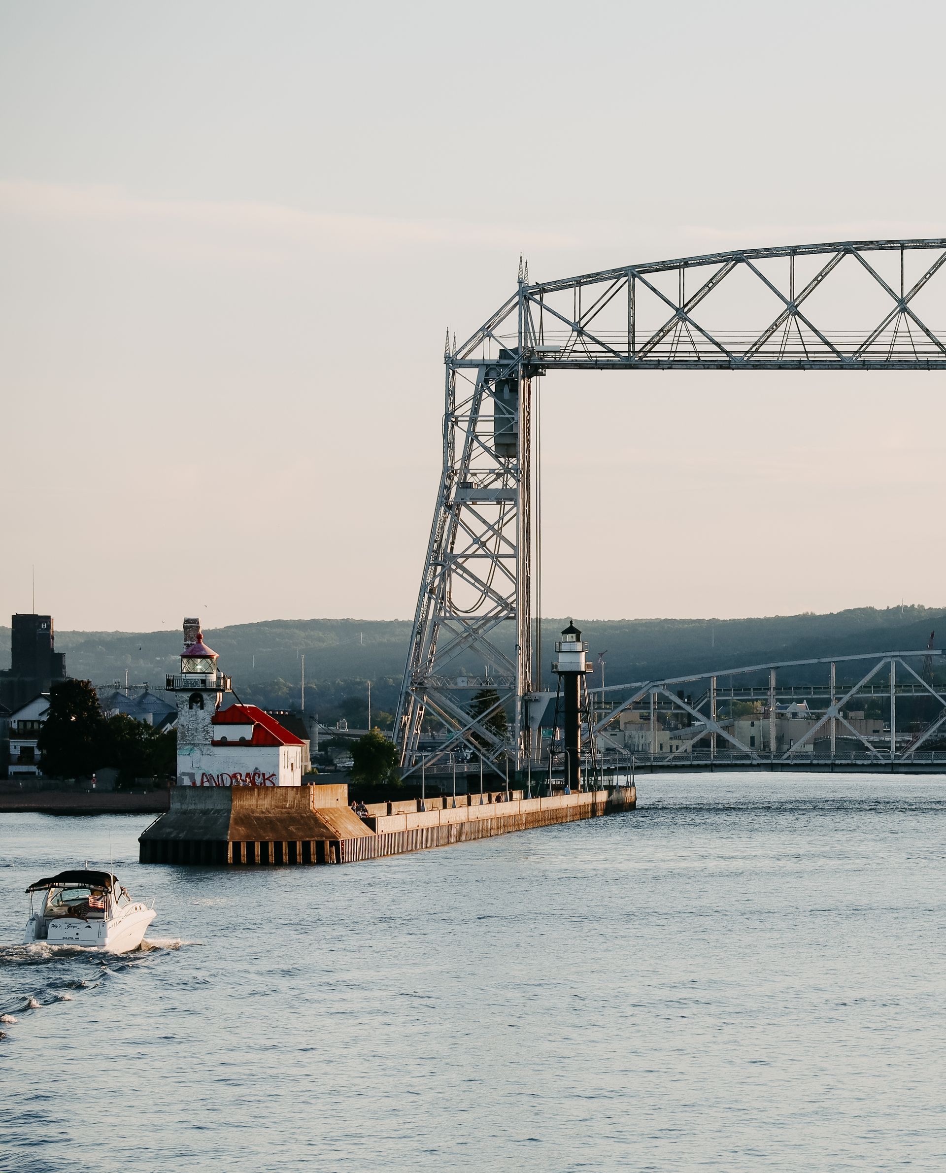boat going under the aerial lift bridge at sunset
