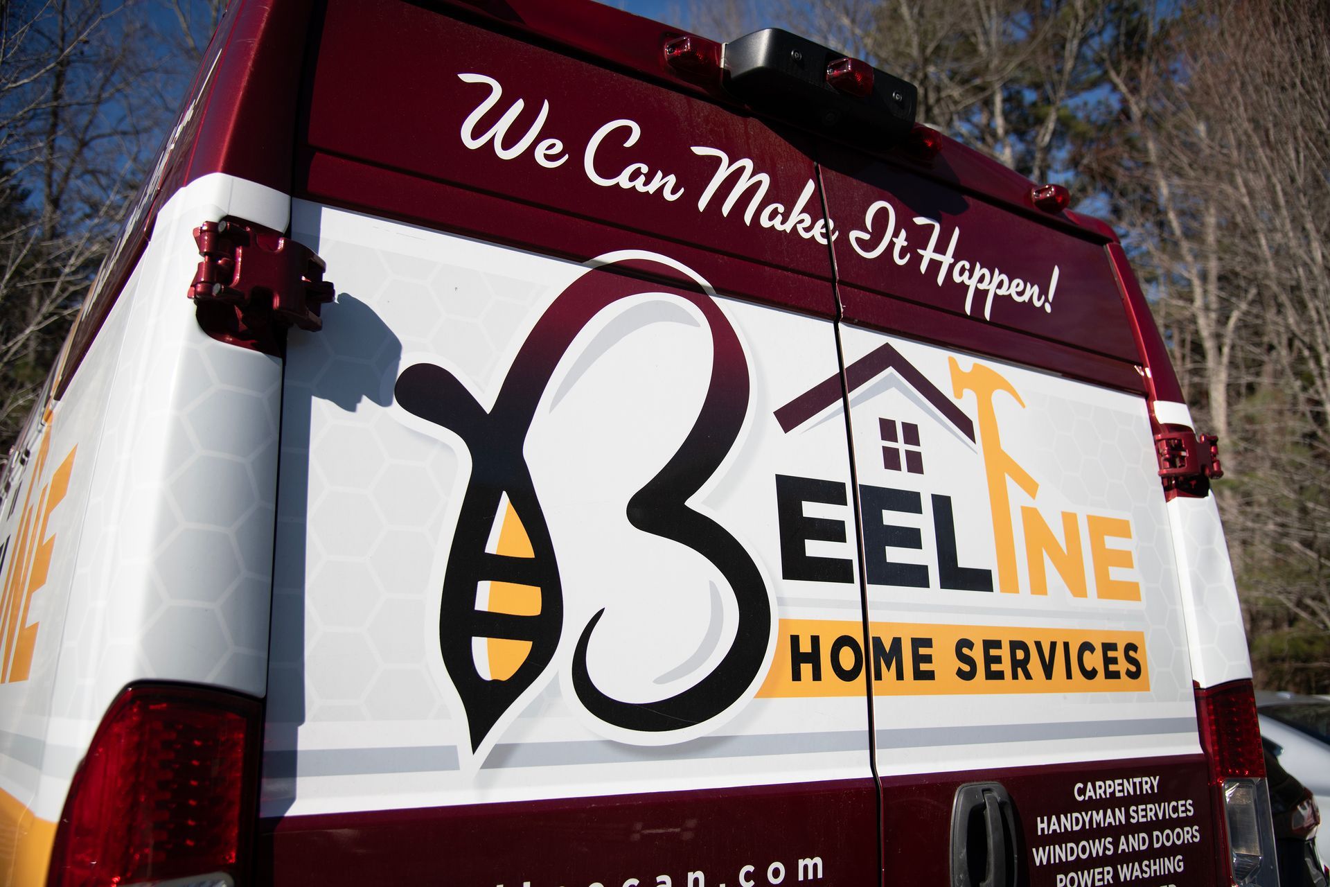 Back of a maroon and white van with 