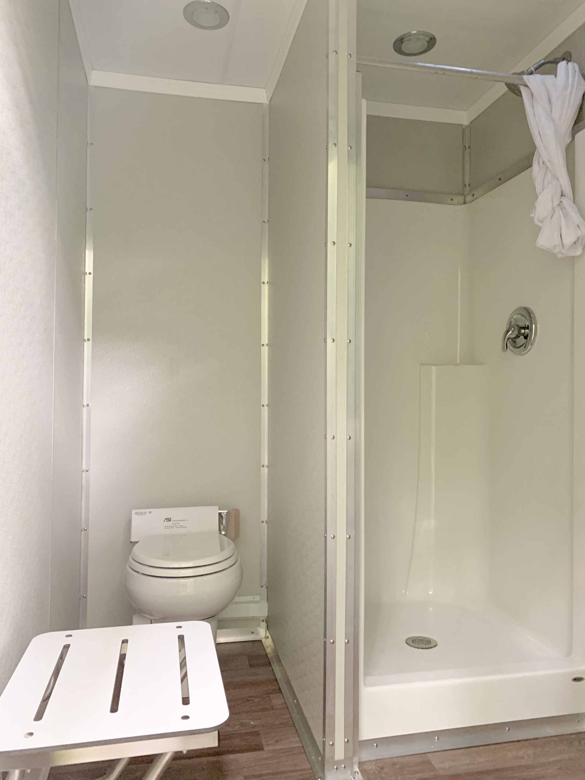 Toilet, shower, and bench
