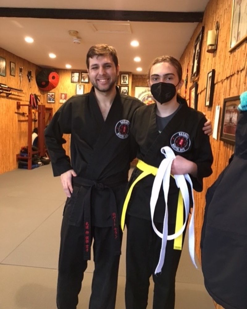 A man and a woman are posing for a picture in a gym