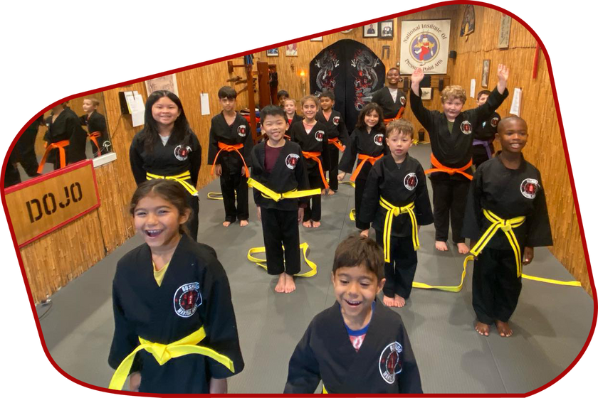 A group of children are standing in front of a sign that says dojo