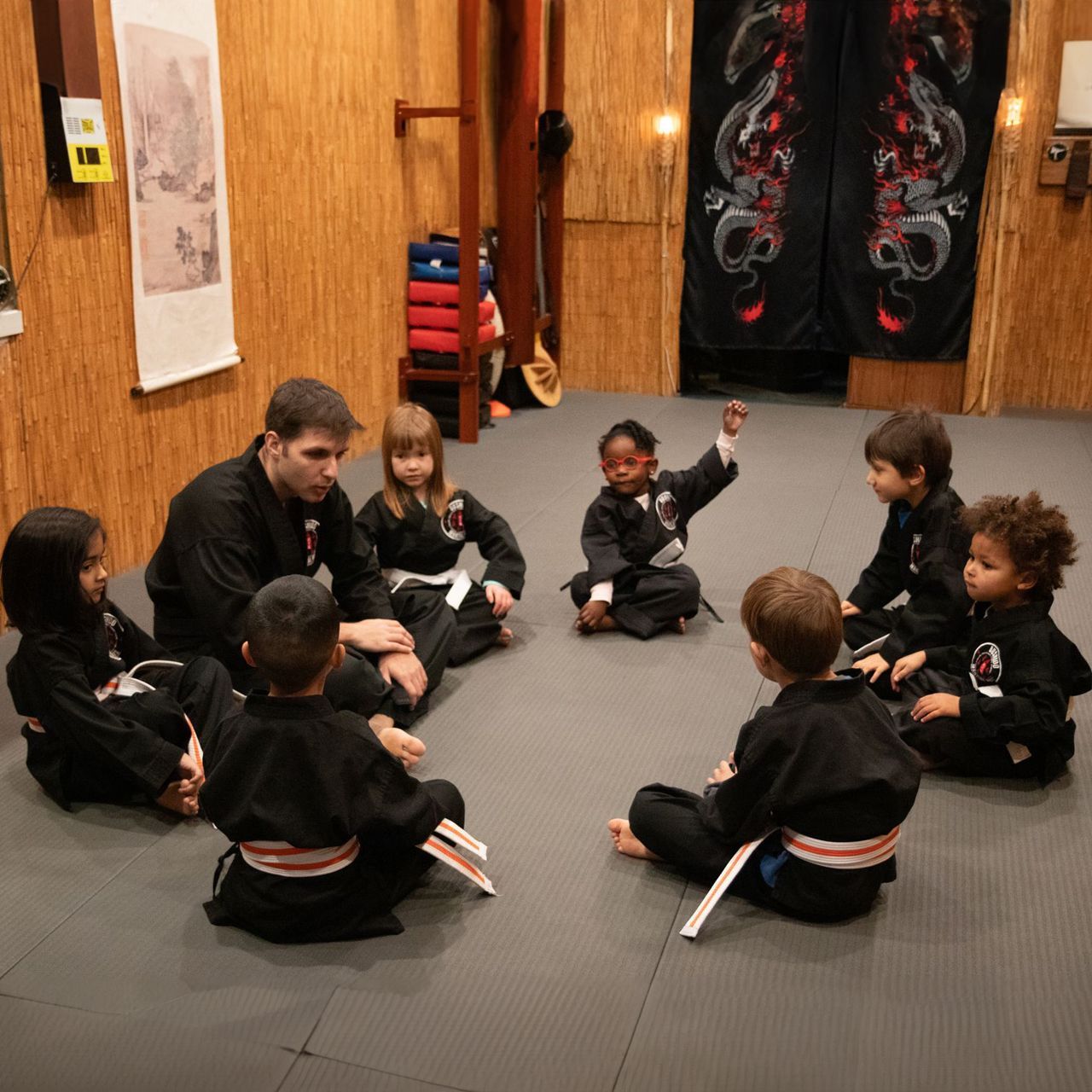 A group of children are sitting in a circle on the floor