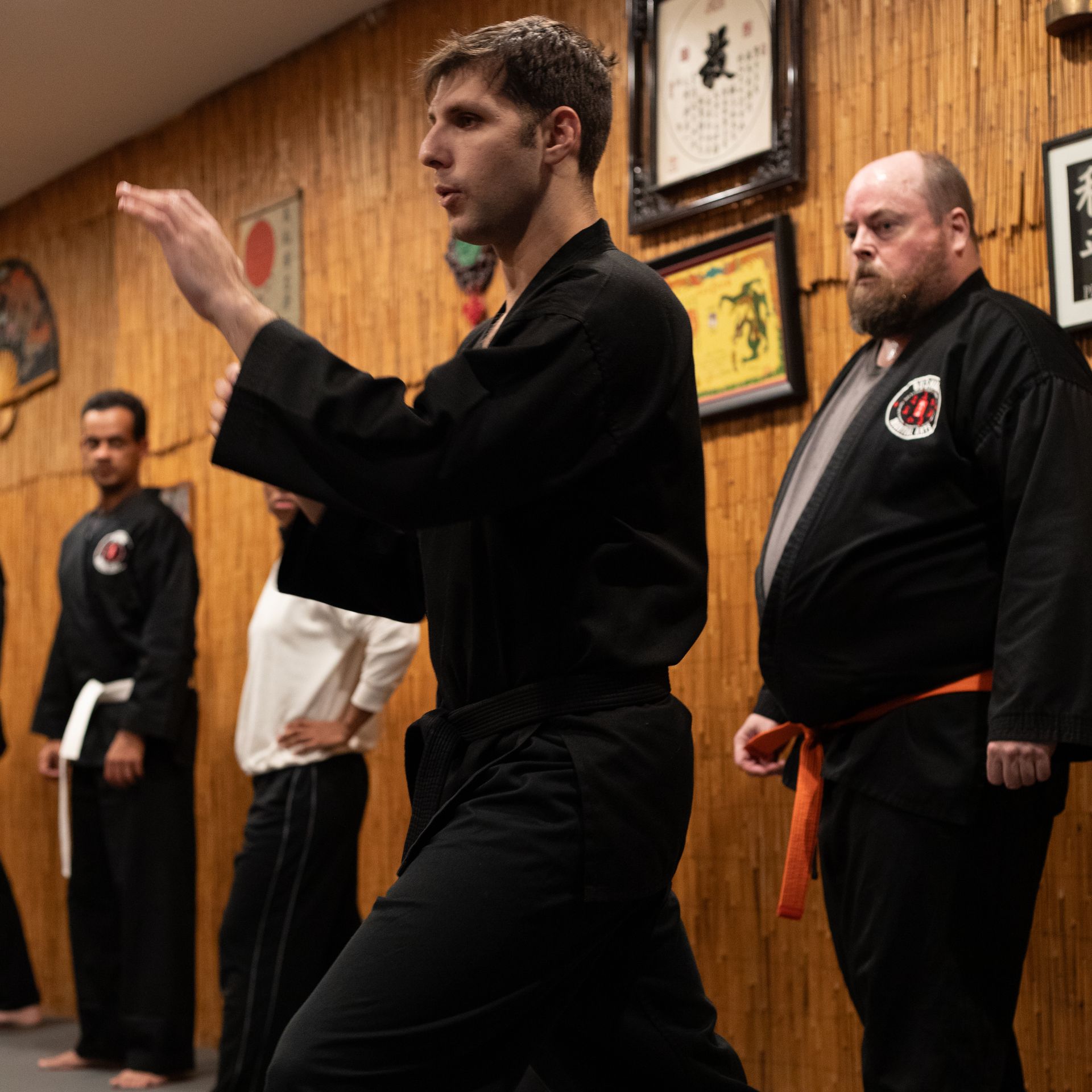 a group of men are practicing karate in a gym