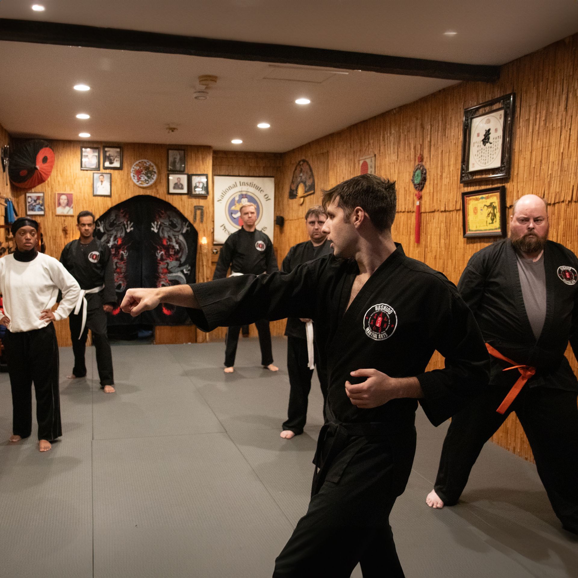 A group of men are practicing martial arts in a gym