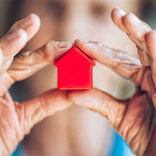 Woman Holding a Miniature House — Fairmont, WV — Pevler Law