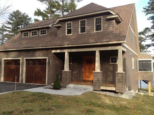 A house with two garage doors and a porch