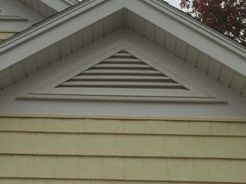 A close up of a house with a triangle on the roof